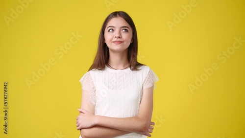 4k video of girl with cunning facial expression on yellow background.