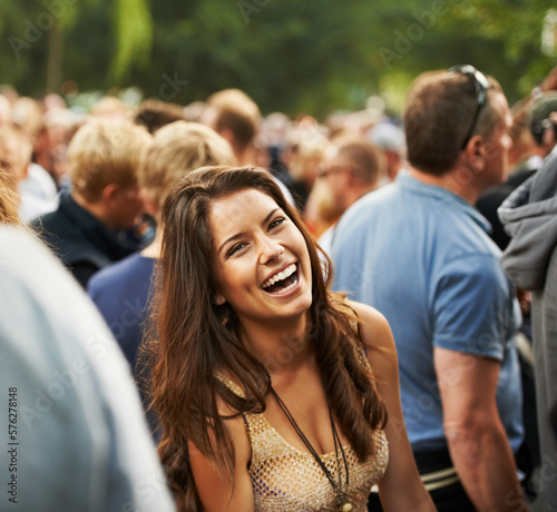 The most fun ever. Portrait of an attractive woman laughing in a crowd at a music festival.