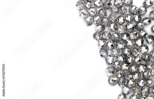 isolate cut close-up silver shiny crystal beads, selective focus with blur effect, background for handicrafts and jewelry, DIY jewelry beads. top view frame, layout