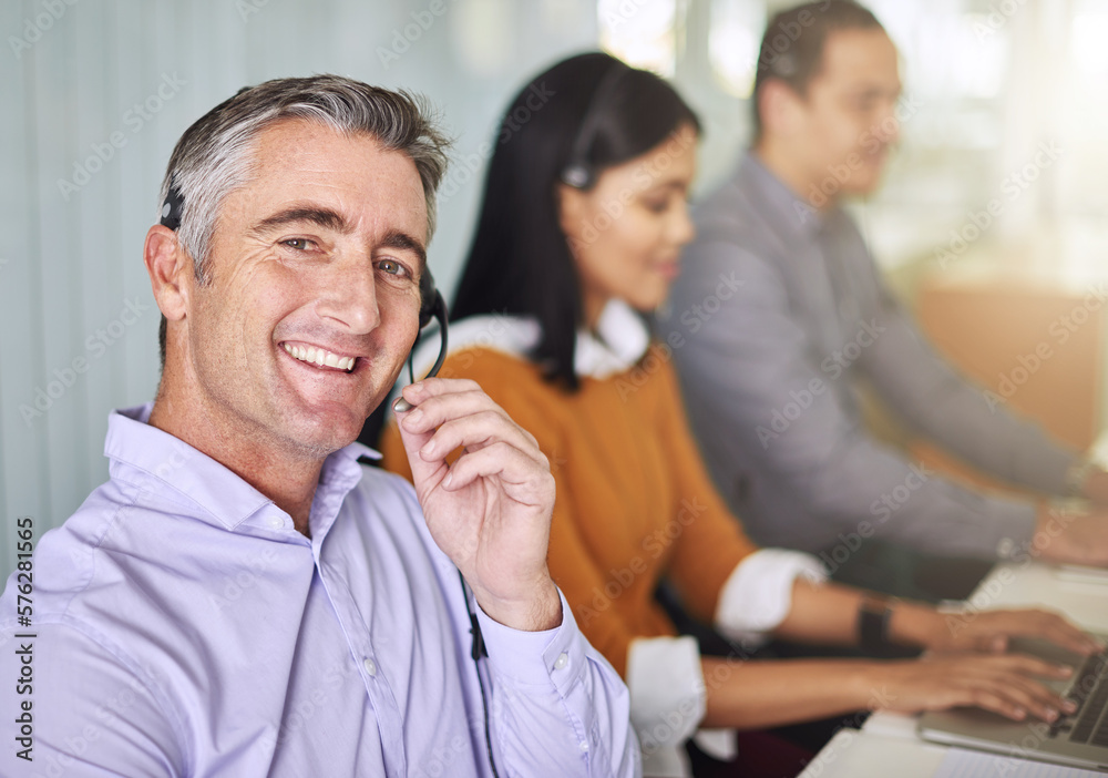 Obraz premium Sure, one second. Cropped portrait of a man working at his desk.