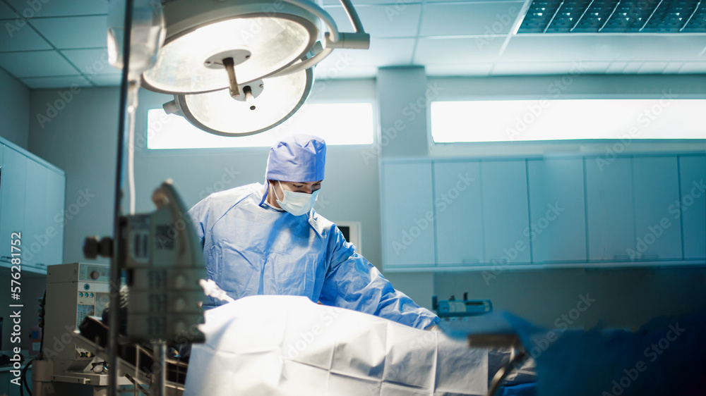 Doctor or Surgeon, Medical team performing surgical operation in bright