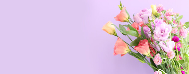 Top view image of pink and purple flowers composition over pastel background