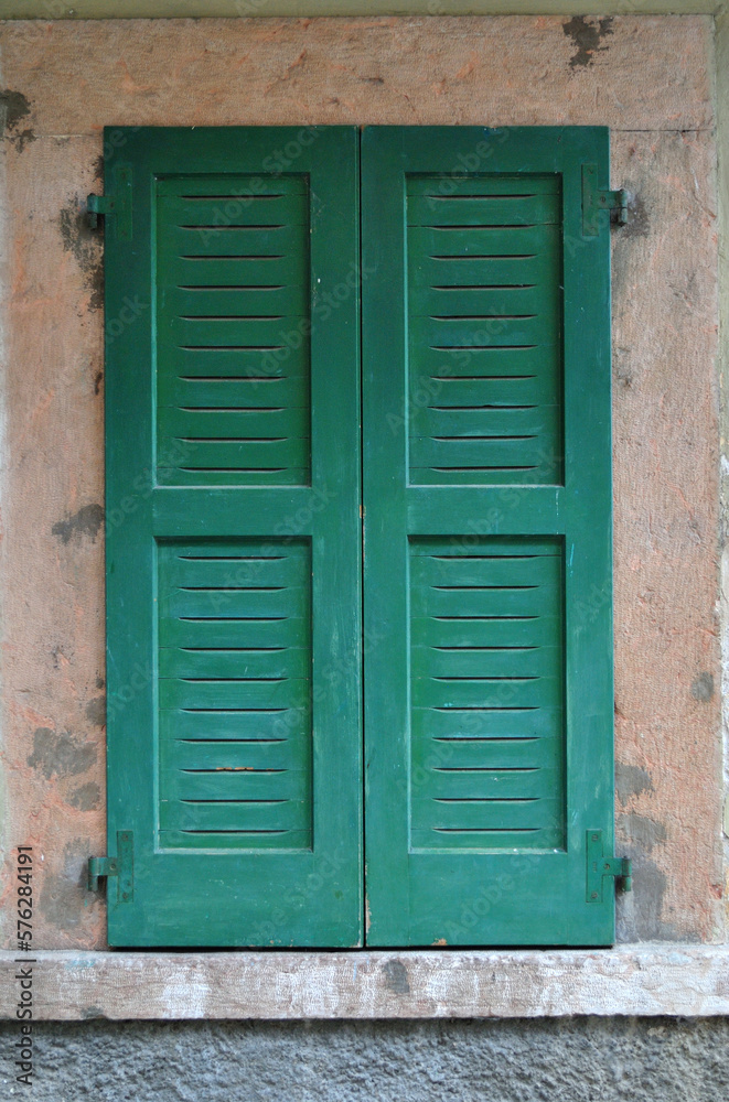 Close Up of Window with Closed Green Wooden Shutters in Old Italian Building  
