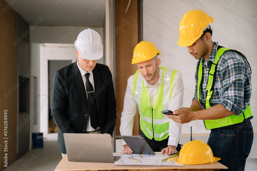 Person's engineer Hand Drawing Plan On Blue Print with architect equipment, Architects discussing at the table, team work and work flow construction concept.