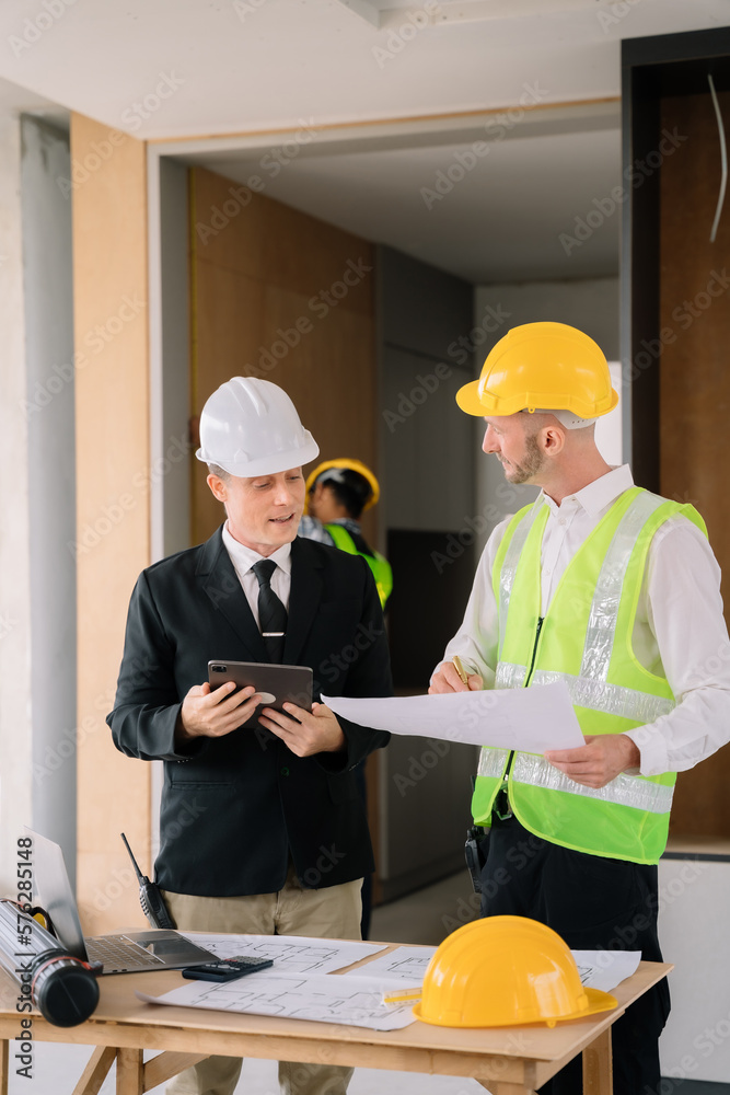 Businessman working as a team discussing data working and tablet, laptop with on on architectural project. Businessman working as a team discussing data working and tablet, laptop with on on architectural project.