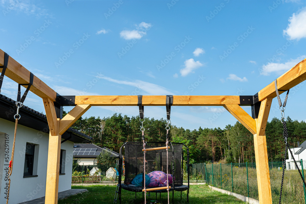 A modern cubic playground made of wooden logs and metal corners, visible nylon ropes and clip hook. A modern cubic playground made of wooden logs and metal corners, visible nylon ropes and clip hook.