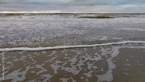 Tilt shot of the north sea on the coast of Egmond aan zee in noord hollland, the Netherlands, during the colder autumn and winter months photo