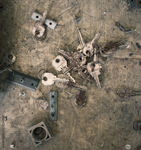 Locksmith background with old keys and lock parts in an abandoned workshop
