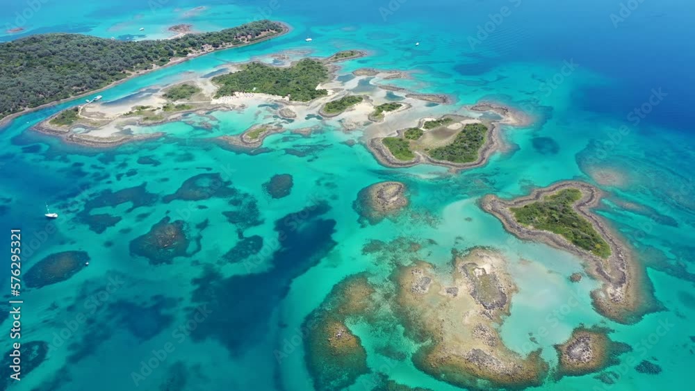 Aerial drone video of tropical exotic volcanic atoll island complex with deep turquoise sea and white sand beaches Aerial drone video of tropical exotic volcanic atoll island complex with deep turquoise sea and white sand beaches