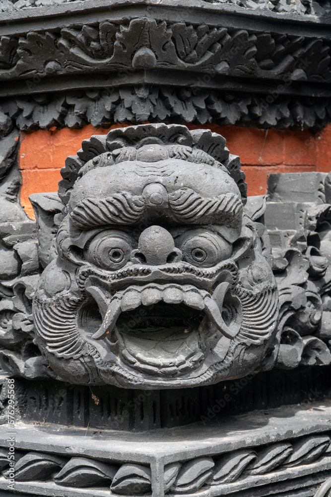 Black masks made of concrete  at the temple's entrance in Nusa Dua, Bali, Indonesia.