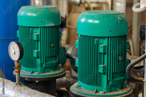 Electric pump with manometer. Pump station in the basement