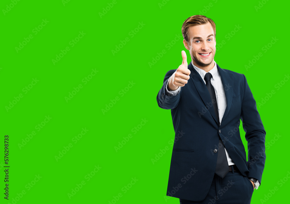 Image of excited businessman showing thumbs up like hand sign gesture, in black suit, green chroma key background. Handsome happy man. Copy space for ad, slogan or text. Image of excited businessman showing thumbs up like hand sign gesture, in black suit, green chroma key background. Handsome happy man. Copy space for ad, slogan or text.