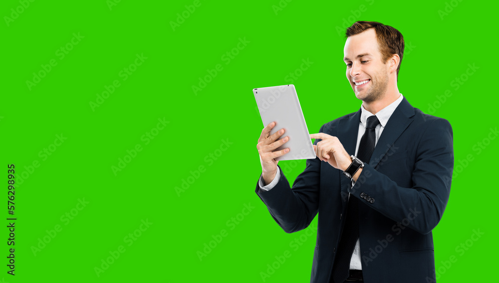 Portrait of smiling businessman in black suit using touchpad tablet pc, green chroma key background. Success in business concept studio picture. Copy space for ad text. Portrait of smiling businessman in black suit using touchpad tablet pc, green chroma key background. Success in business concept studio picture. Copy space for ad text.
