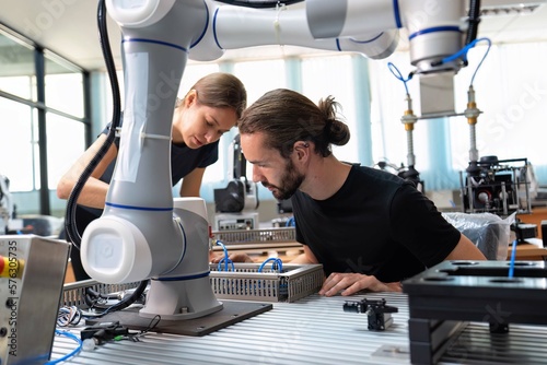 An engineer in research development robotic factory checking prototype of automation robot arm