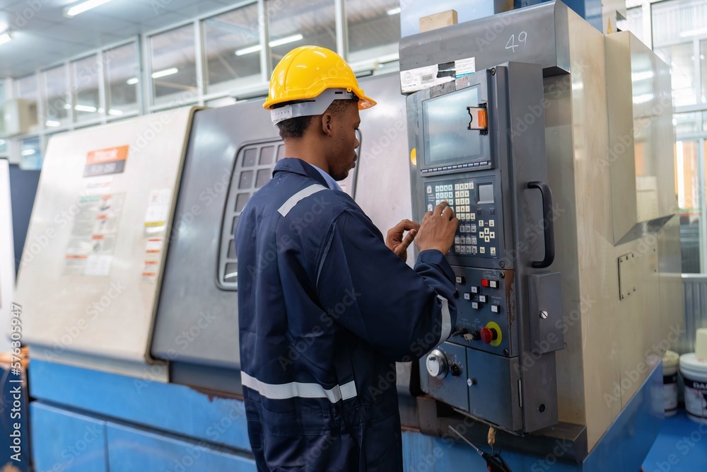 An engineer use programmable control panel program operate machinery cutting machine An engineer use programmable control panel program operate machinery cutting machine