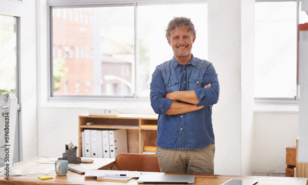 Finally, I have an office with a window. Portrait of a mature businessman standing with his arms folded behind his desk. Finally, I have an office with a window. Portrait of a mature businessman standing with his arms folded behind his desk.