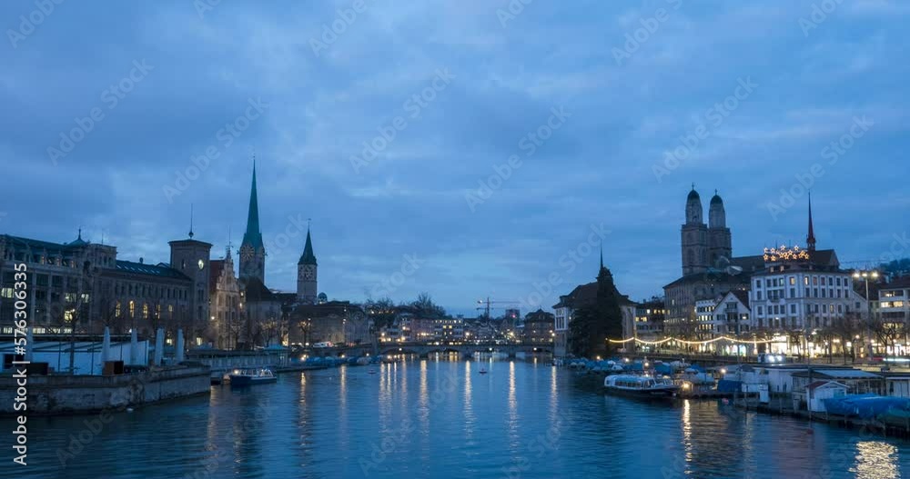 Historic city center of Zurich, the largest city in Switzerland. Beautiful blue hour cityscape panorama view timelapse from the river by night. Downtown of swiss during dramatic sunset in time lapse. Historic city center of Zurich, the largest city in Switzerland. Beautiful blue hour cityscape panorama view timelapse from the river by night. Downtown of swiss during dramatic sunset in time lapse.