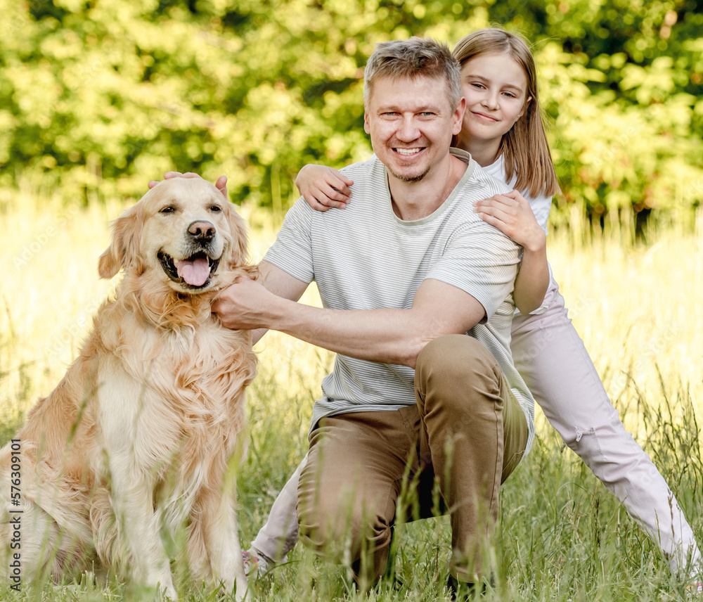 Dad and his daugter play with dog Dad and his daugter play with dog