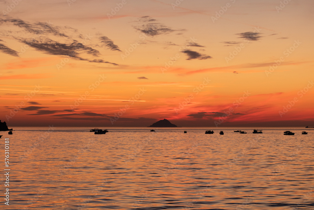 Boats in the sea at sunset.
