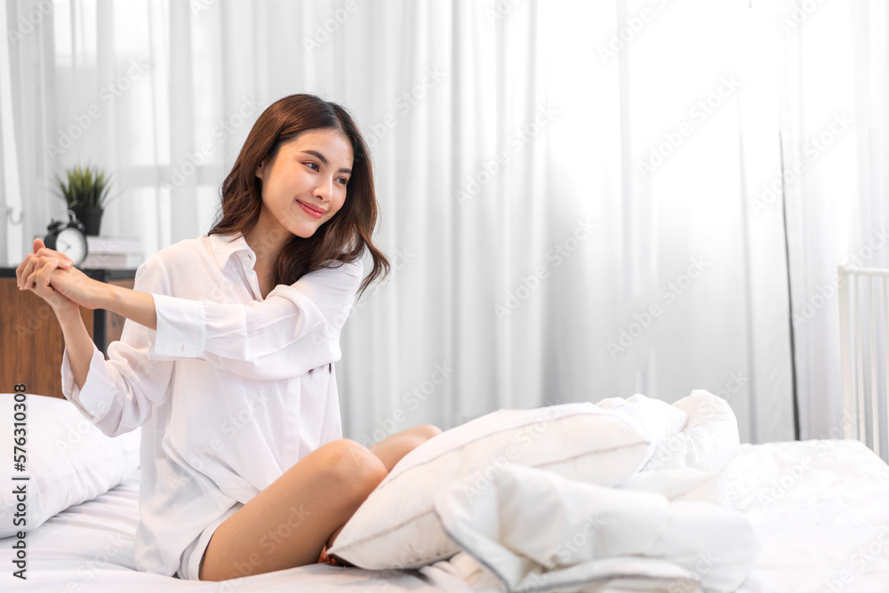 Portrait of smiling cheerful beautiful pretty asian woman clean fresh healthy white skin posing smile in pajamas white clothes.Girl felling relax and enjoy time on the bed at home.asia beauty Portrait of smiling cheerful beautiful pretty asian woman clean fresh healthy white skin posing smile in pajamas white clothes.Girl felling relax and enjoy time on the bed at home.asia beauty