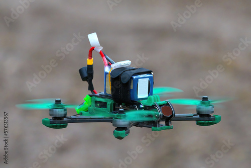 drone in flight in blur. Freestyle FPV unmanned quadcopter with blurry hills. The concept of new technologies and innovations. photo