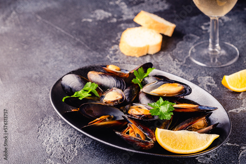 Delicious seafood mussels with sauce and parsley.