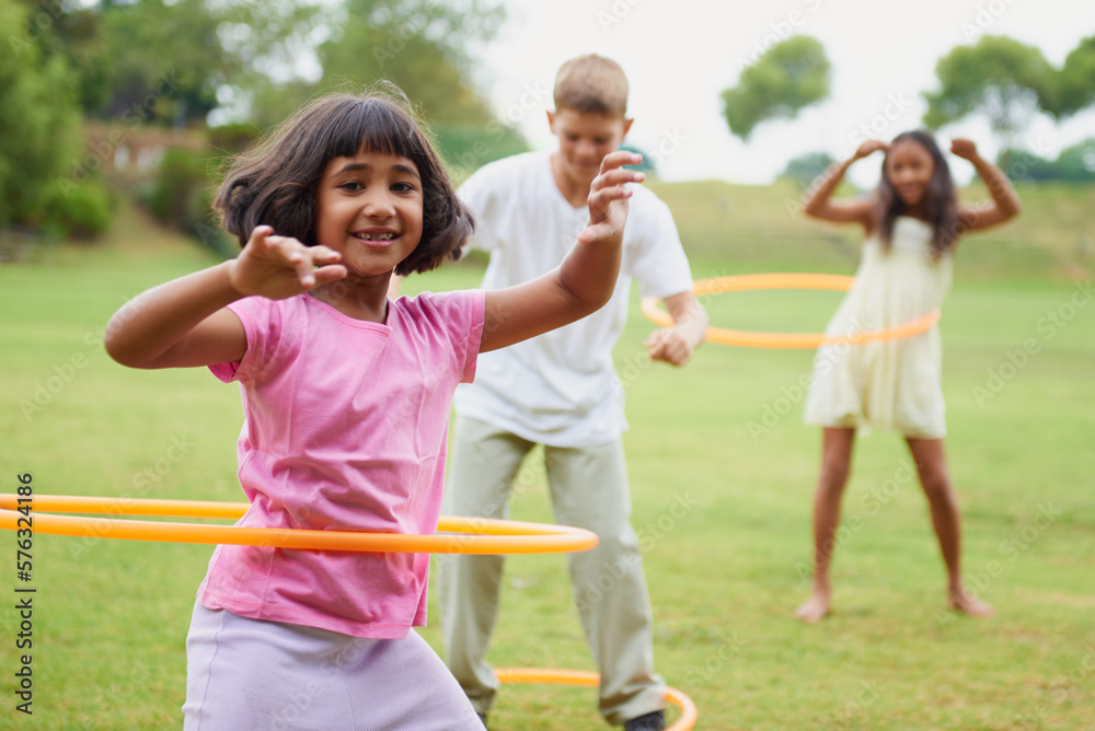 Spin like yourve never spun before. Three children playing with hula hoops outside. Spin like yourve never spun before. Three children playing with hula hoops outside.