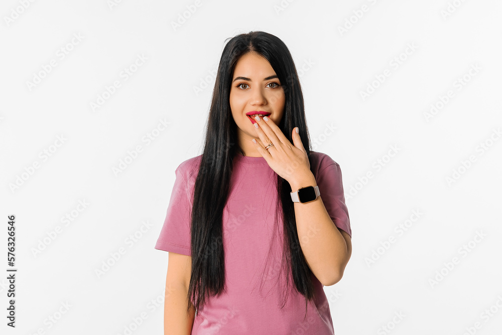 Portrait of girl looking shocked after hearing something, touches her mouth and looks speechless, stands over white background Portrait of girl looking shocked after hearing something, touches her mouth and looks speechless, stands over white background