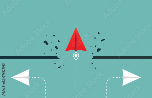 Overcoming obstacles, barrier, target, goal with red paper plane breaking through obstacle when the others paper plane don't. Business solution or leadership and effort for growth and success photo
