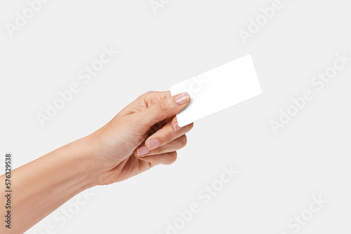 Woman's hand showing credit card, or card, or business card or voucher, isolated on white background, template, mock-up