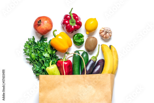 Eco friendly paper shop bag with raw organic green vegetables isolated on white background Flat lay, top view Zero waste, plastic free concept Healthy clean eating diet and detox, agriculture concept