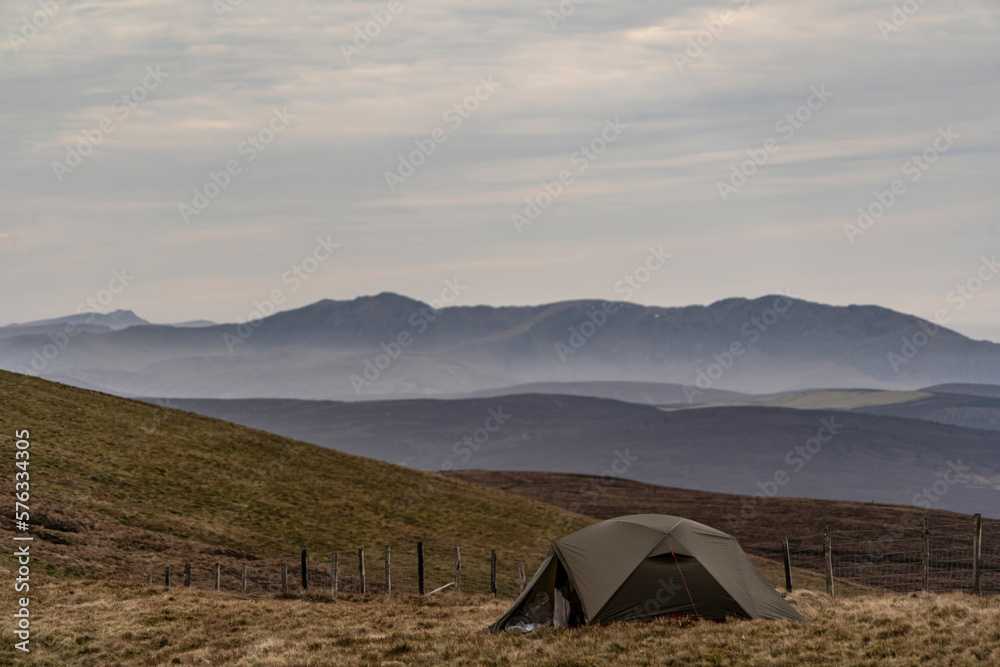 A wild camping tent on Cadair Berwyn with views of Snowdonia in Wales