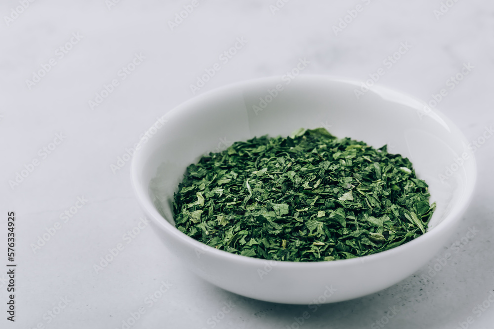 Parsley. Dried herb parsley green leaves in bowl Parsley. Dried herb parsley green leaves in bowl