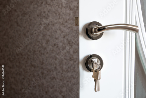 Door handle and keyhole with bunch of keys © Vastram