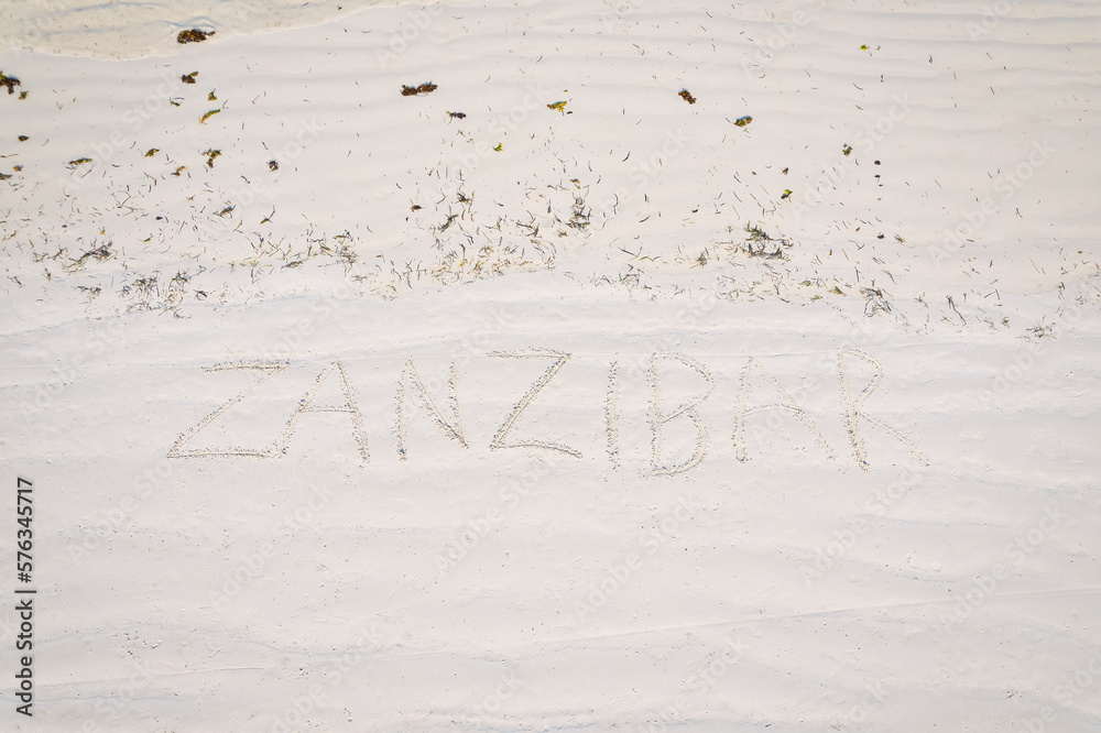 Etched into the sand of Zanzibar's vacation beach is a captivating inscription. Etched into the sand of Zanzibar's vacation beach is a captivating inscription.