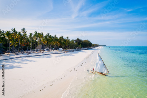 Behold the breathtaking aerial footage of Zanzibar's Kiwengwa beach, a tropical paradise with swaying palms and crystal-clear waters