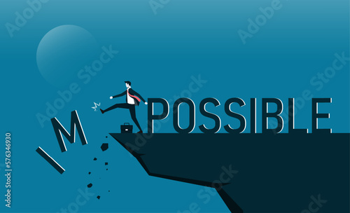 Businessman change impossible to possible text on top mountain, Business, success, challenge, motivation, achievement and goal concept.