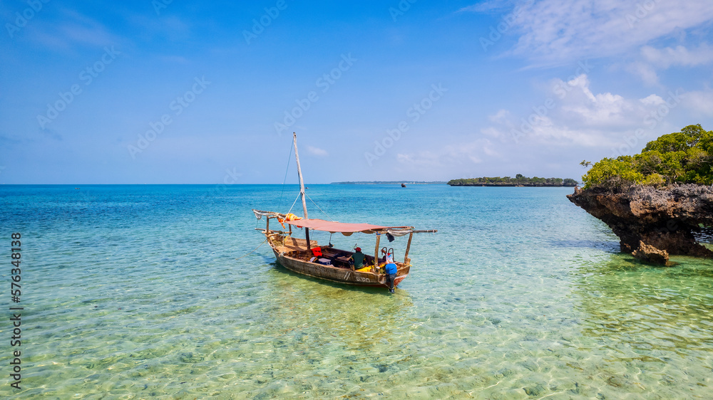 Board a traditional wooden dhow boat and discover the natural wonders of Zanzibar's Blue Safari, from coral reefs to deserted islands. Board a traditional wooden dhow boat and discover the natural wonders of Zanzibar's Blue Safari, from coral reefs to deserted islands.