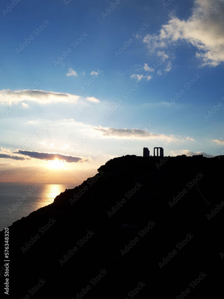 Poseidon's Temple near Athens in Greece. The sunset and in the distance, the ancient temple and the sea. Temple of Poseidon, Sounion. Poseidon's Temple near Athens in Greece. The sunset and in the distance, the ancient temple and the sea. Temple of Poseidon, Sounion.