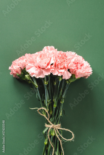 Fototapeta Naklejka Na Ścianę i Meble -  Bouquet of pink carnations flower on green background. Woman's day or Mother's day greeting card.