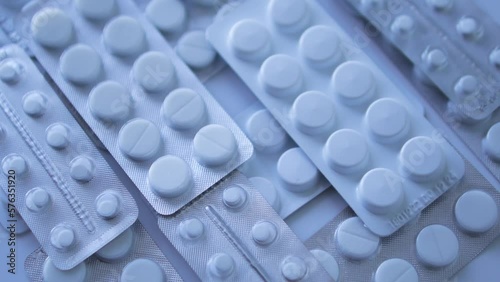 Many different blister packs with tablets lying on table, counterfeit medicines, cheap and unlicensed analogues, criminal case