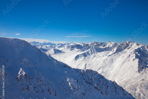 Beautiful landscape of winter mountains over clouds.