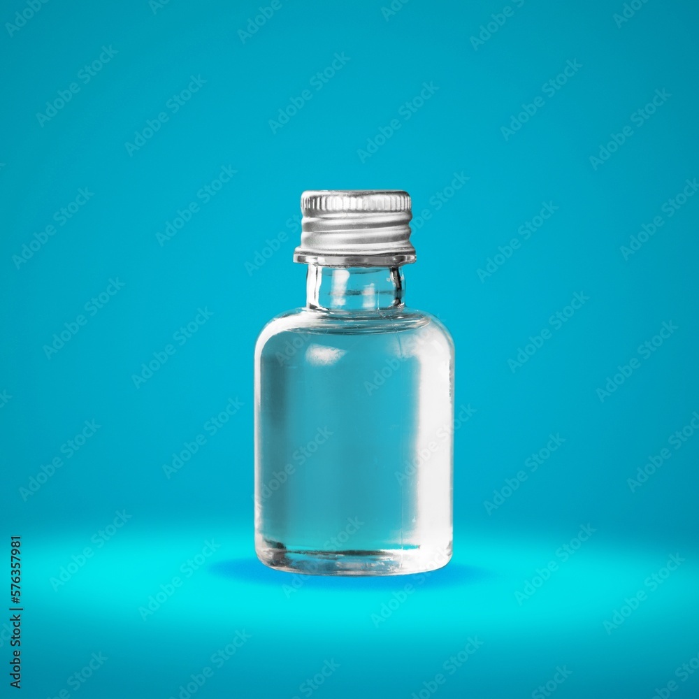 Liquid in glassware bottle on color background