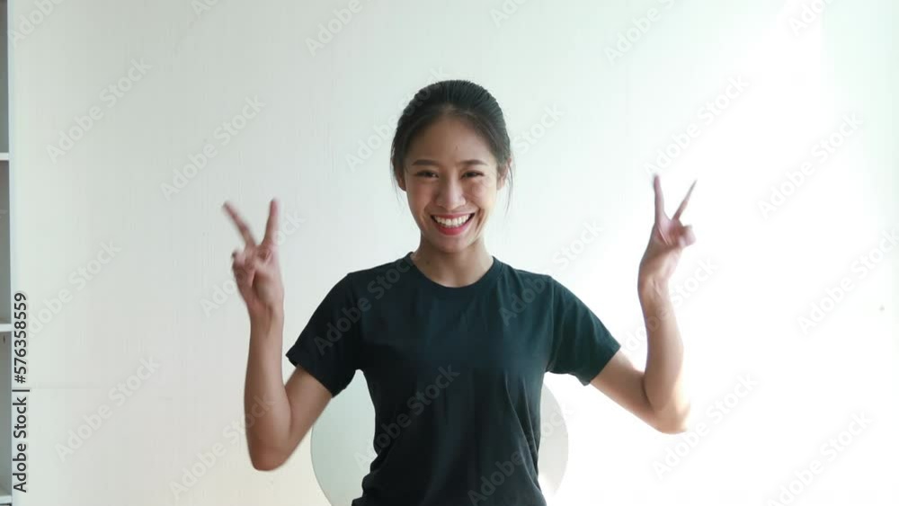 Woman making two thumbs up gesture showing joy and fun, Symbol of good friendship, Popular photo poses, Make a v-shaped finger, White background. Woman making two thumbs up gesture showing joy and fun, Symbol of good friendship, Popular photo poses, Make a v-shaped finger, White background.