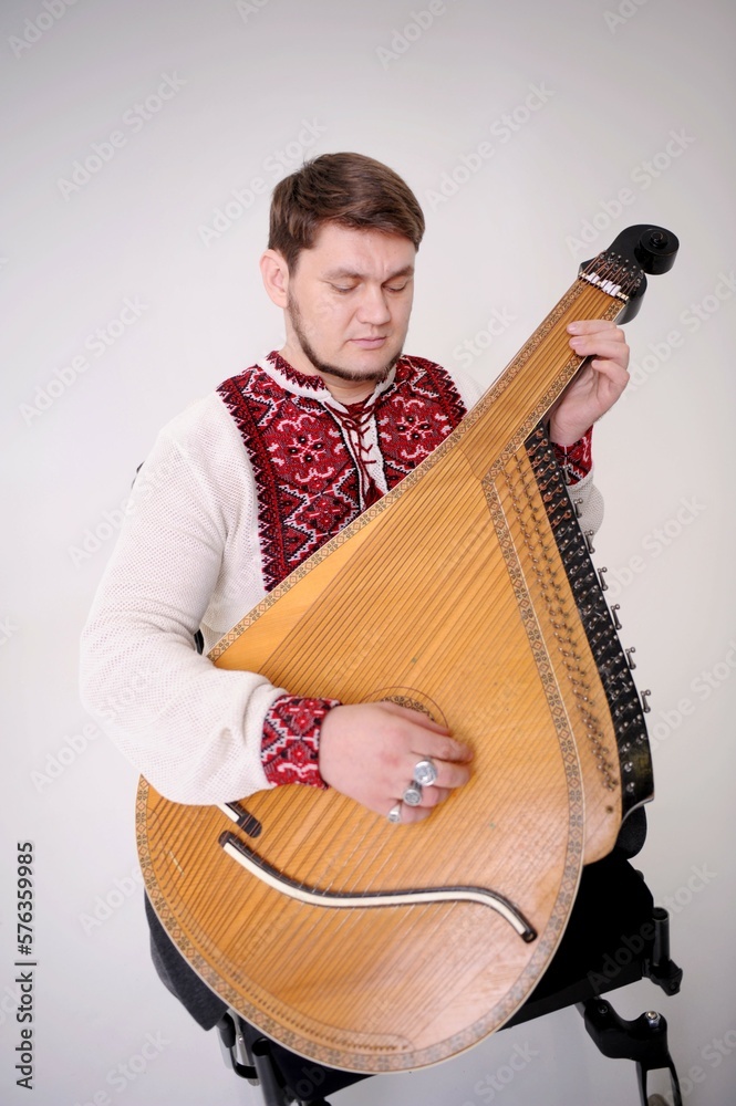 strong Ukrainian Cossack in an embroidered shirt Red cross-stitch on a ...