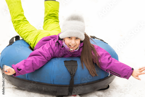 Children ride on tubing. Winter entertainment. Tubing. People roll on the slides.
