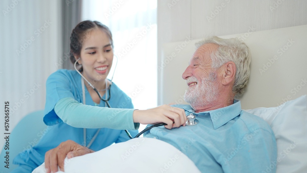 Fototapeta premium Female nurse hold stethoscope listen to elderly male patient heart rate. Happy caring woman nurse use phonendoscope measure heartbeat of senior man in hospital