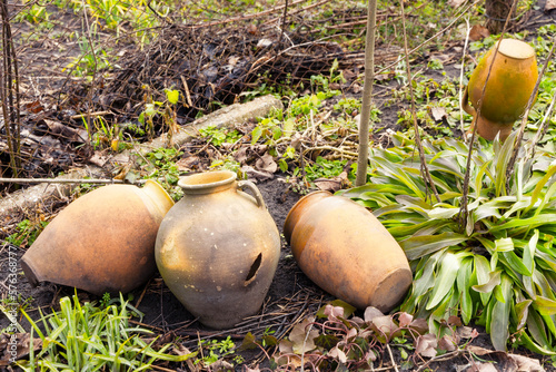 Broken earthenware jugs lie on the ground. Village still life.
