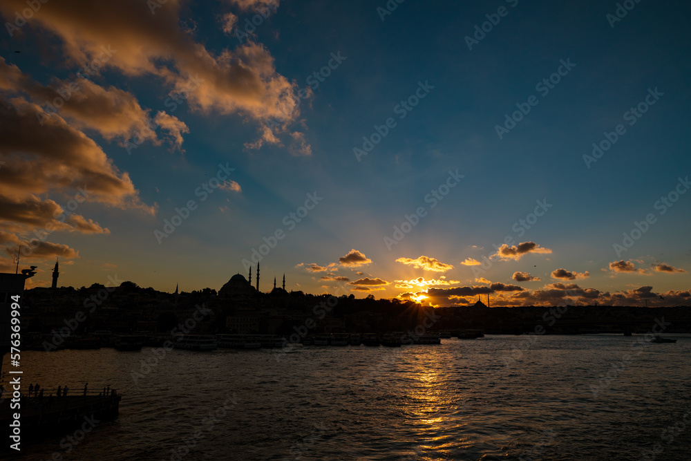 Silhoeutte of Istanbul at sunset with dramatic clouds and sunrays
