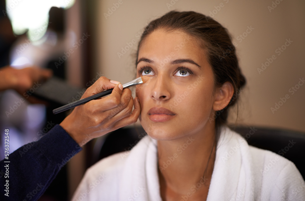 Makeover time. Shot of an attractive young woman having makeup applied to her face. Makeover time. Shot of an attractive young woman having makeup applied to her face.